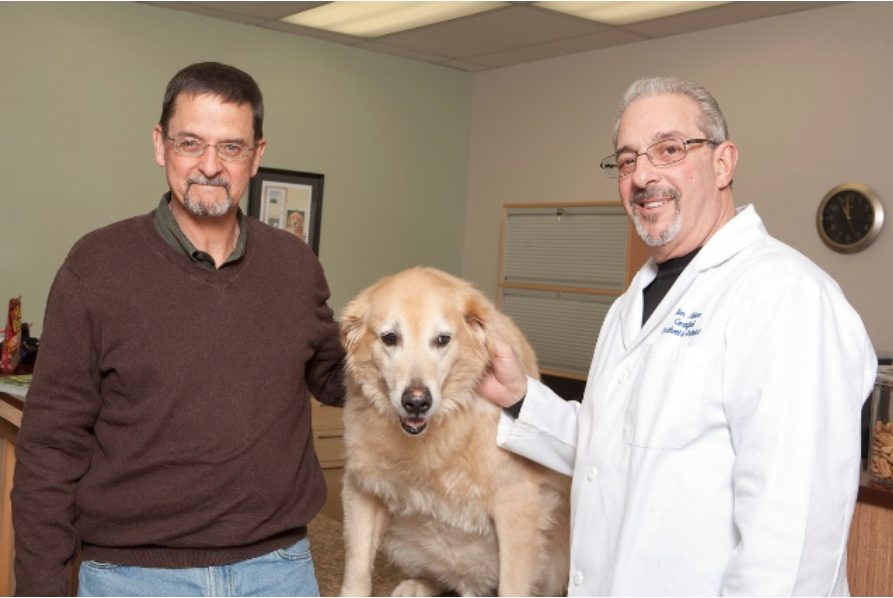 Founders Mark Hardin and Jim Alaimo pose with a golden-colored dog